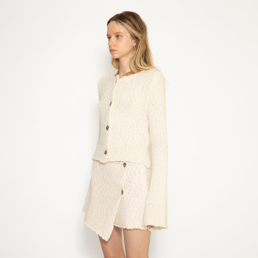 Louise alpaca wool cardigan from three-quarter side paired with Thelma alpaca wool cardigan 